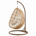 Sedia a dondolo in metallo e rattan con cuscino beige