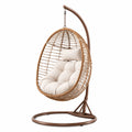 Sedia a dondolo sospesa in rattan e acciaio con cuscino crema